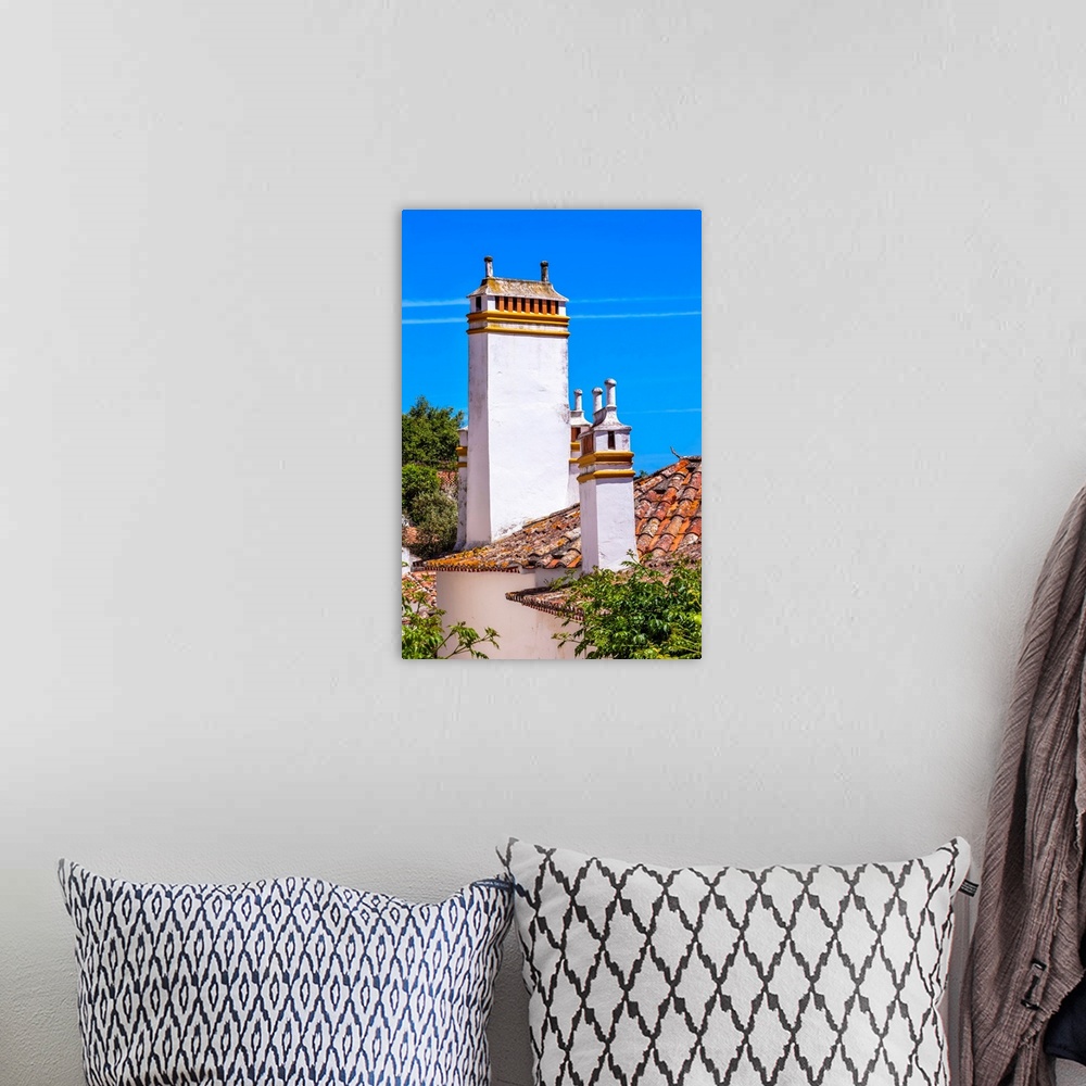A bohemian room featuring Towers Chimnies Orange Roofs Medieval Town Obidos Portugal. Castle and walls built in 11th centur...