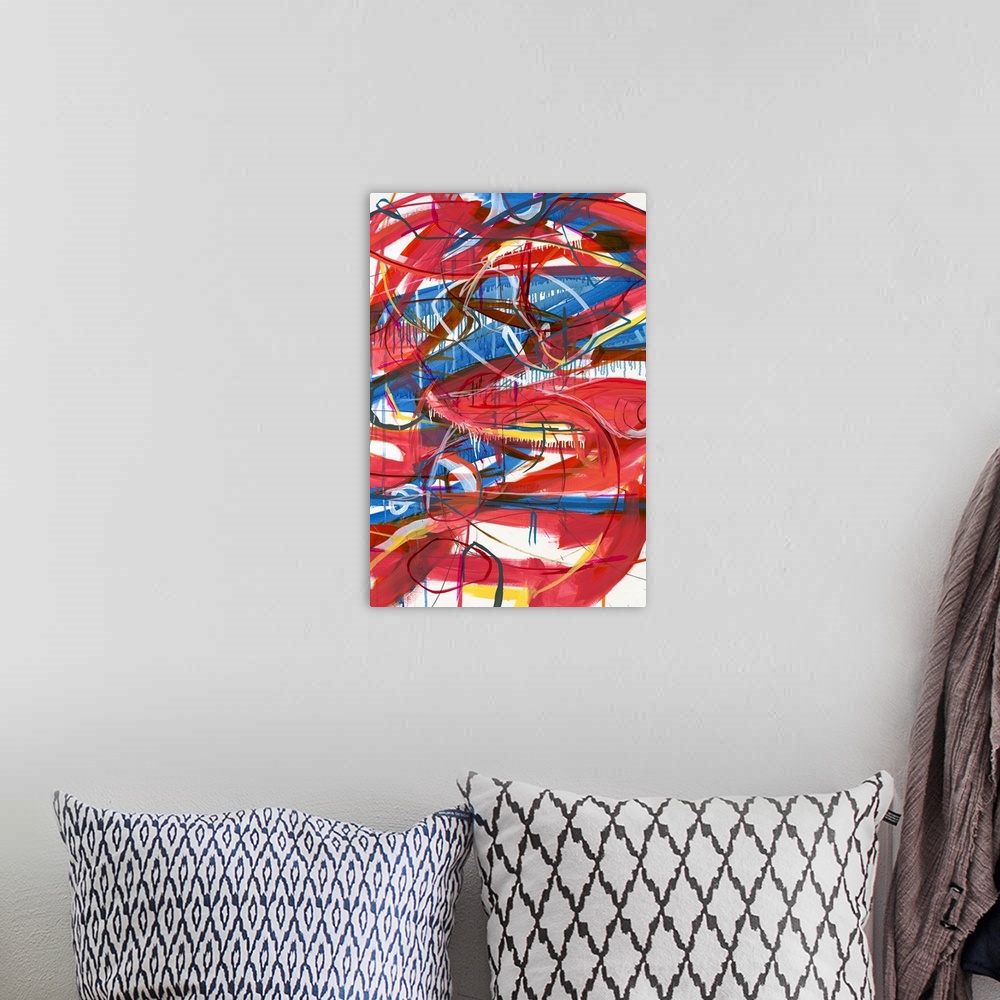 A bohemian room featuring Large abstract painting with red, blue, magenta, yellow, orange, and white lines varying in size ...
