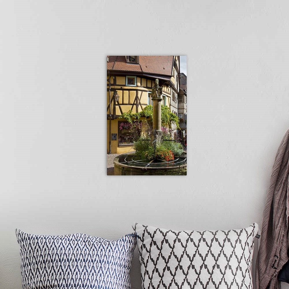 A bohemian room featuring France, Alsace, Riquewihr, Haut-Rhin, Picturesque fountain in the village centre
