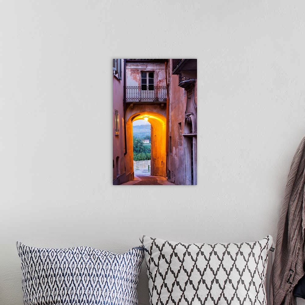 A bohemian room featuring Italy, Piedmont, Cuneo district, Langhe, Carru, A passageway in the Piazza del Mercato