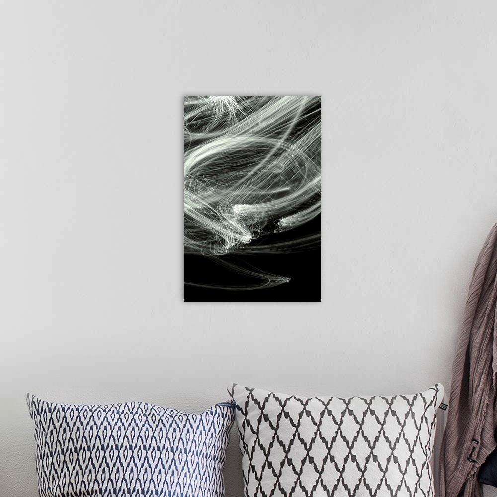 A bohemian room featuring Long exposure abstract photograph of white light trails giving a smokey look with a black backgro...