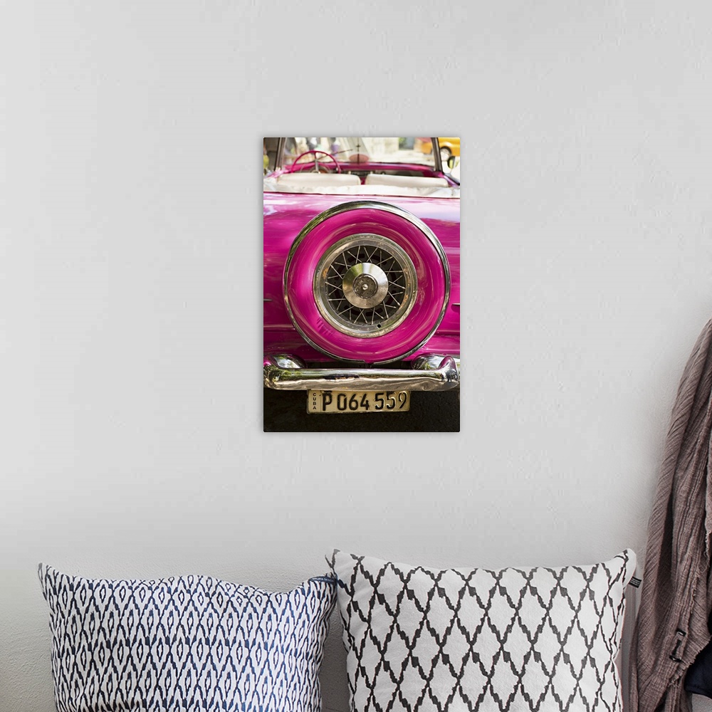 A bohemian room featuring Photograph of the spare tire case on the back of a vintage hot pink car in Cuba.