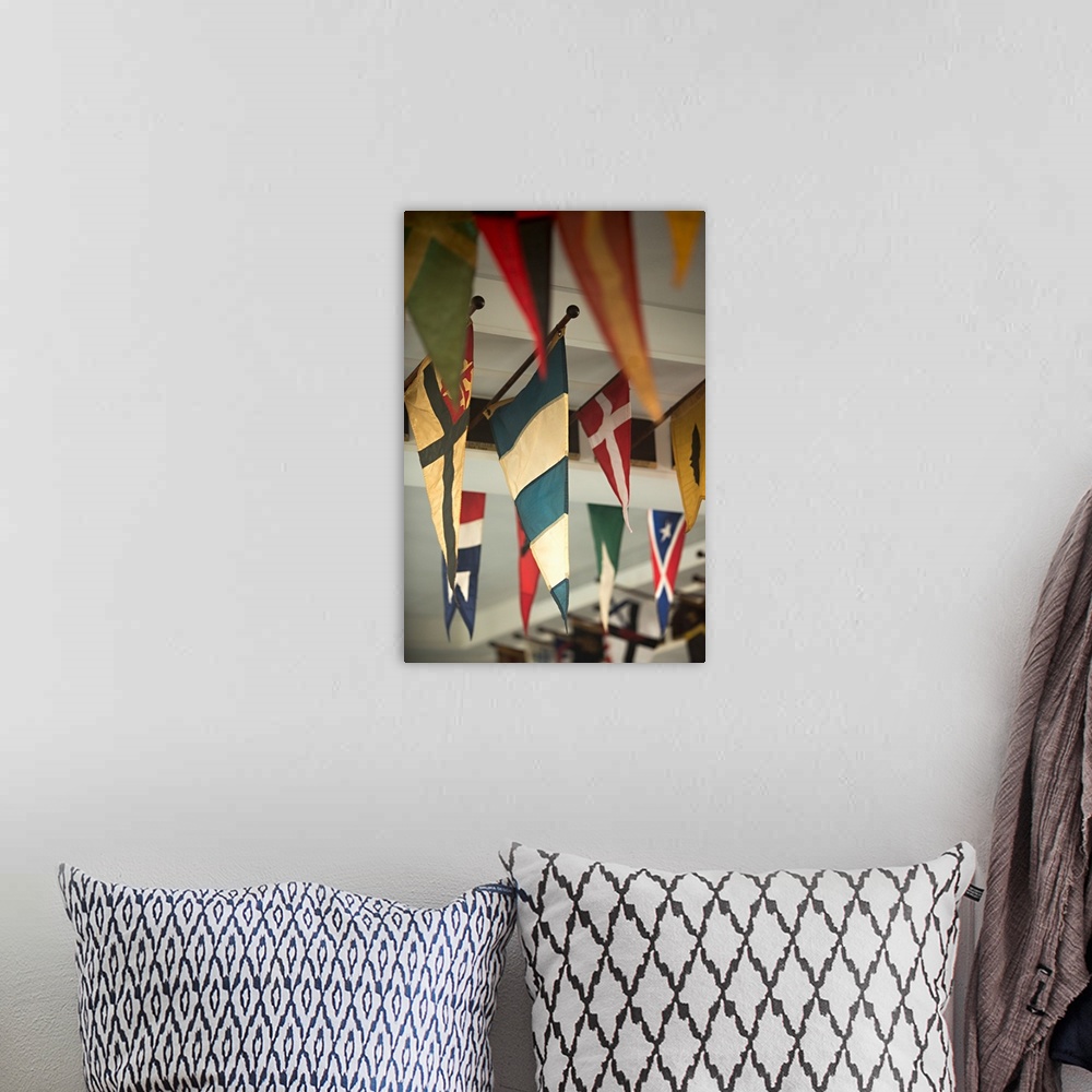 A bohemian room featuring Close-up photograph of flags hanging on the ceiling of a yacht club.