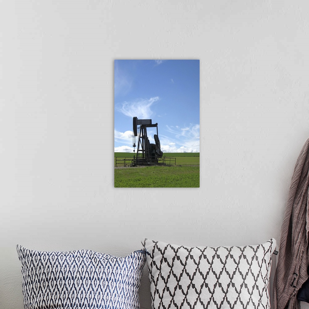A bohemian room featuring An oil pumpjack stands alone in a prairie field in Southern Alberta.