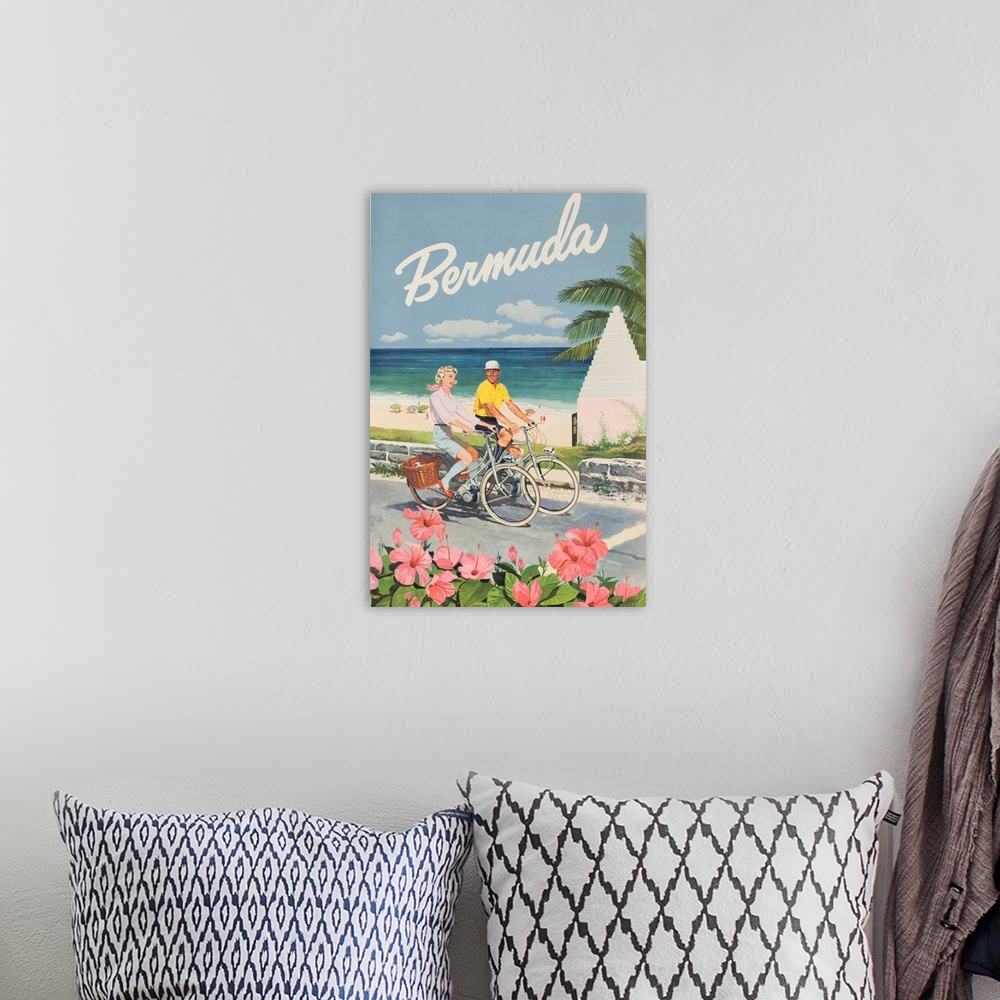 A bohemian room featuring ca 1960s Bermuda Travel Poster showing a happy couple riding bicycles on a beachside path.