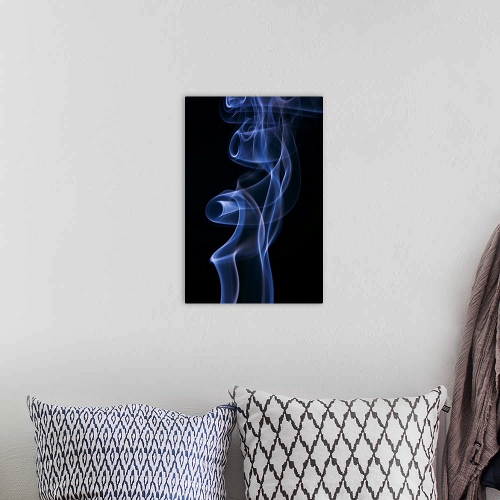 A bohemian room featuring Blue and white smoke on black background
