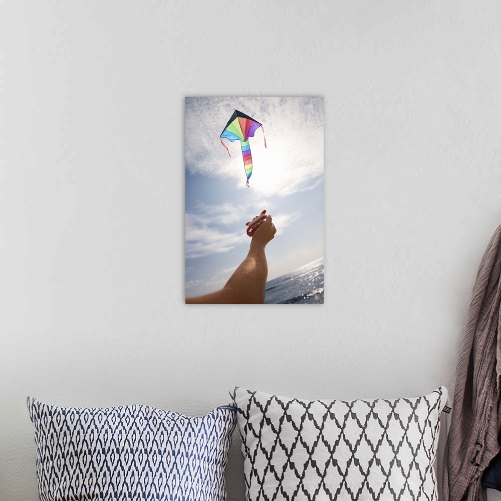 A bohemian room featuring Hand holding string of flying kite