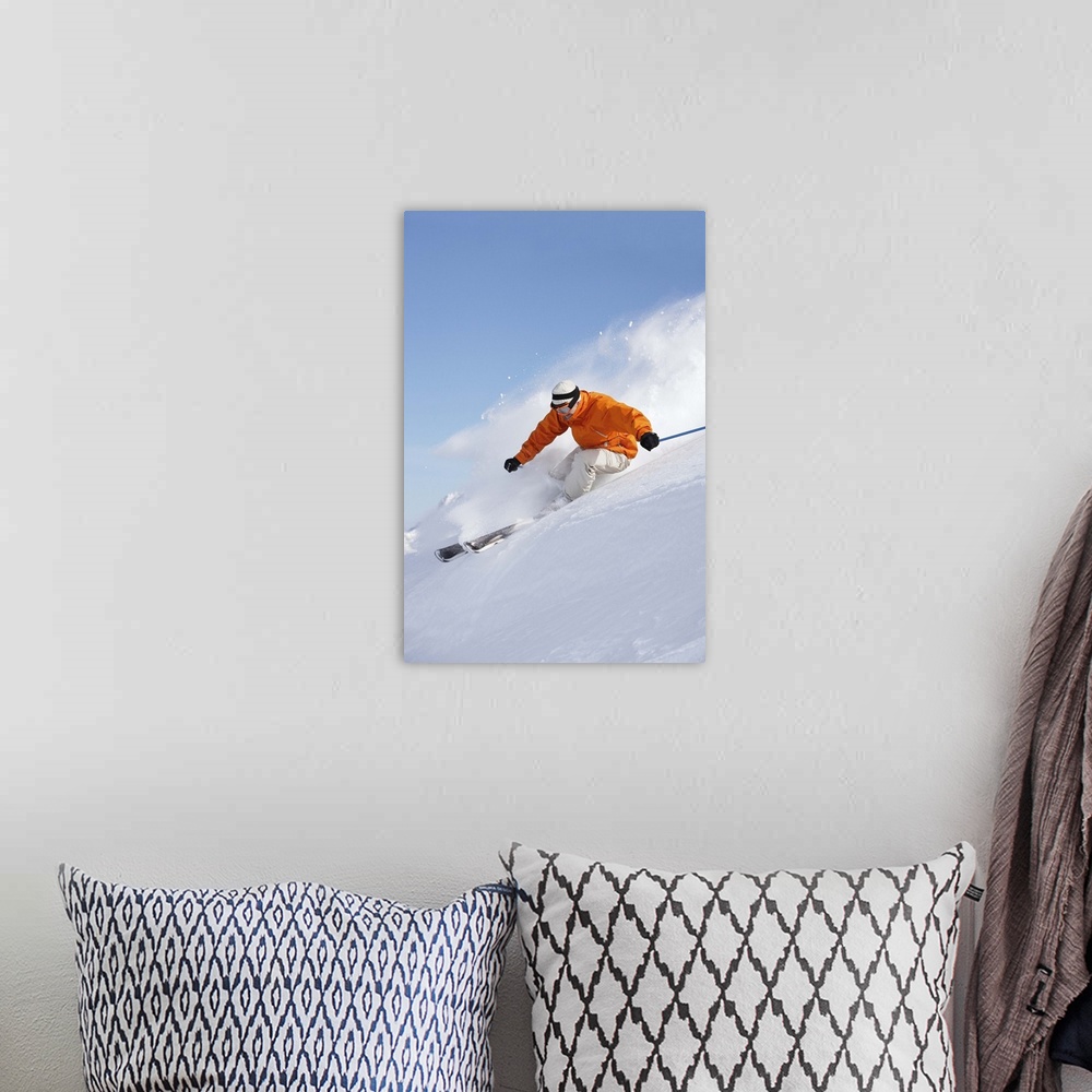 A bohemian room featuring Man skiing down snow mountain slope sending up spray