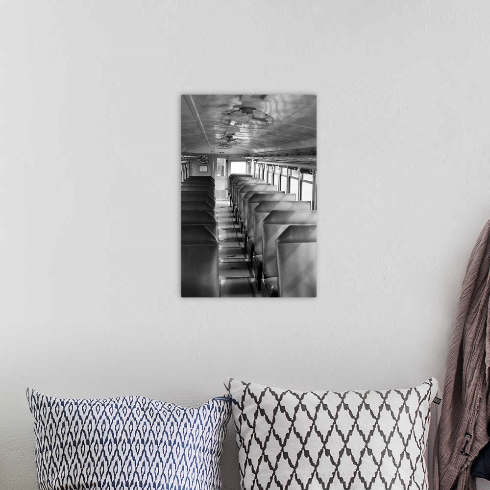 A bohemian room featuring Black and white image of old passenger car of train.