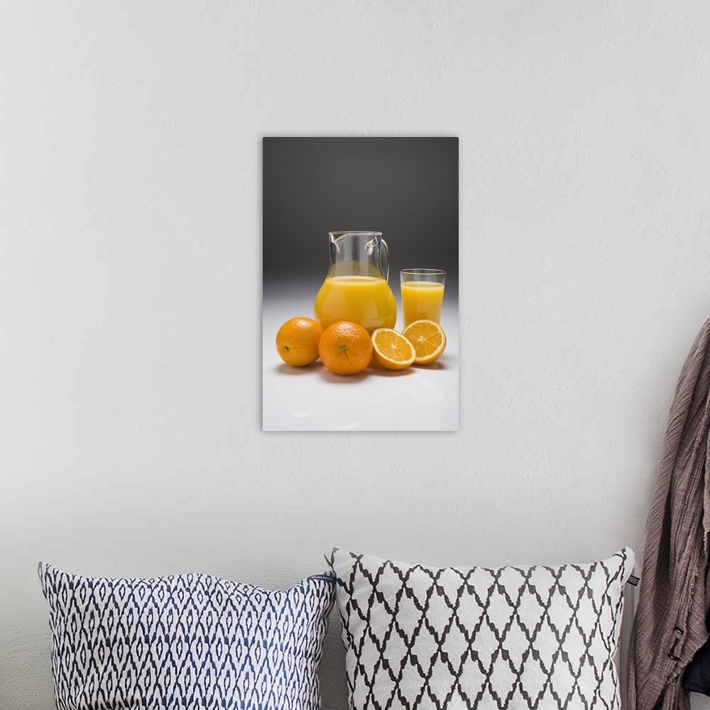 A bohemian room featuring Oranges with a Pitcher and a Glass of Orange Juice