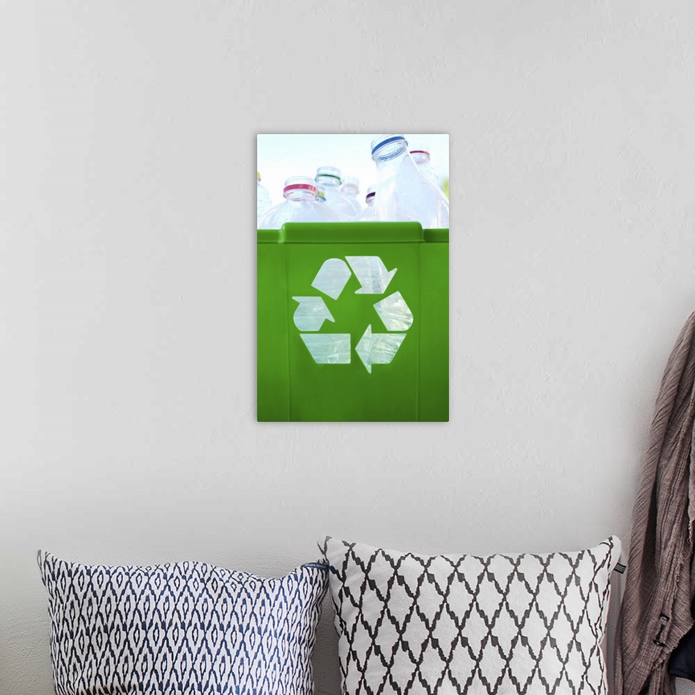 A bohemian room featuring Recycling logo cut out of green plastic container