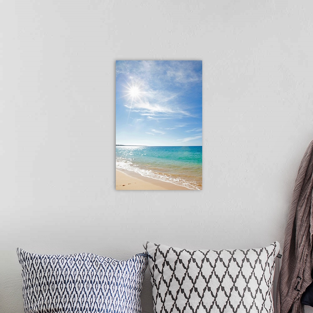A bohemian room featuring Photograph of shoreline with surf rolling in under a cloudy sky.  The sun is shinning and sparkli...