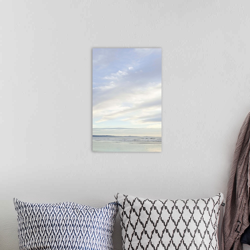 A bohemian room featuring Sunrise on Woodend beach, Christchurch, South Island New Zealand, portrait composition, cloudy da...