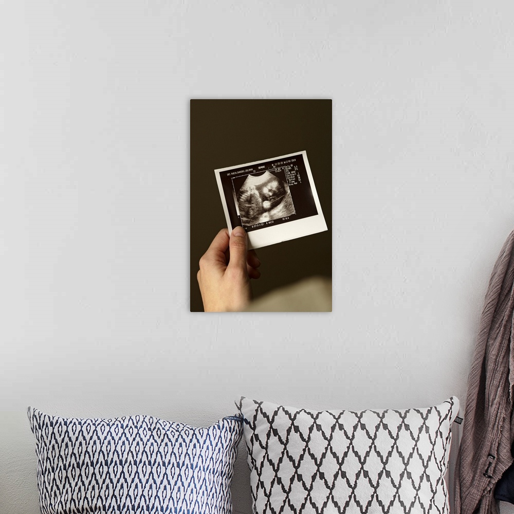 A bohemian room featuring Woman holding ultrasonograph photo of baby