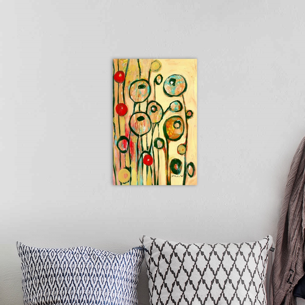 A bohemian room featuring Large, portrait contemporary art of circular, modern poppy shapes springing upward on a golden, w...