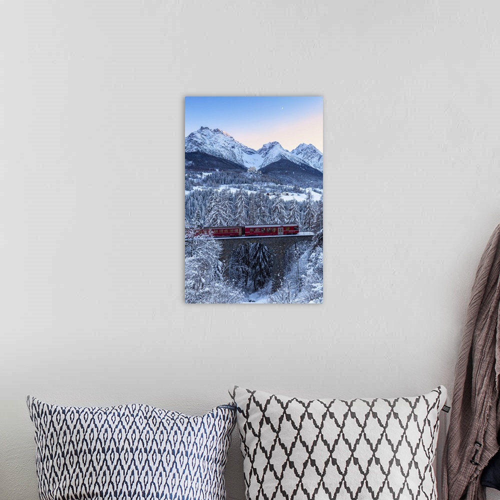 A bohemian room featuring Bernina Express transit on the viaduct in winter. Lower Engadine, Canton of Grisons, Switzerland,...