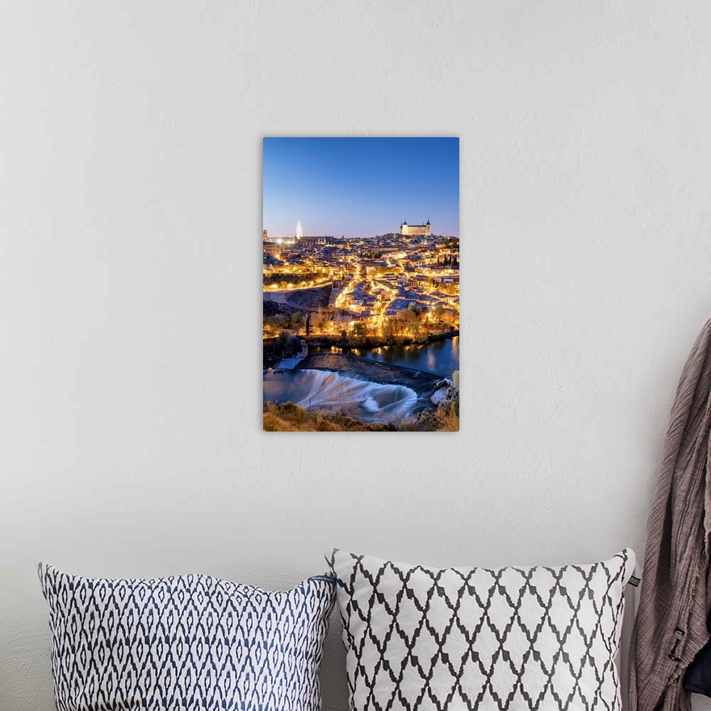 A bohemian room featuring Toledo and the Tagus river at twilight, a UNESCO World Heritage Site. Castilla la Mancha, Spain.