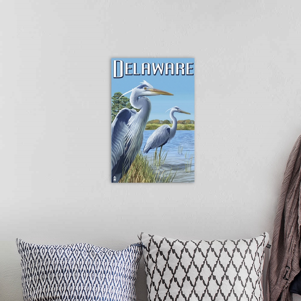 A bohemian room featuring Retro stylized art poster of two blue herons staring out onto the water.