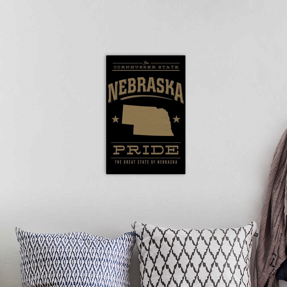 A bohemian room featuring The Nebraska state outline on black with gold text.