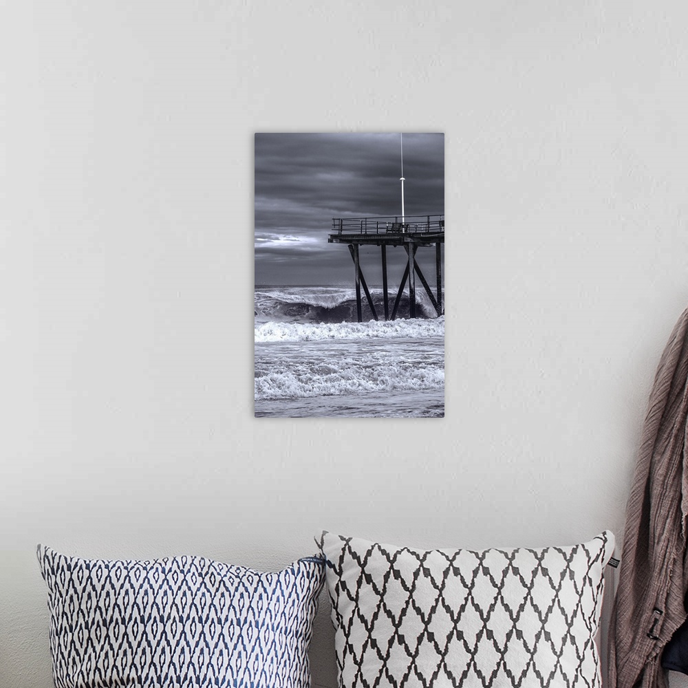 A bohemian room featuring Pier over rough ocean waters during a storm in New Jersey.