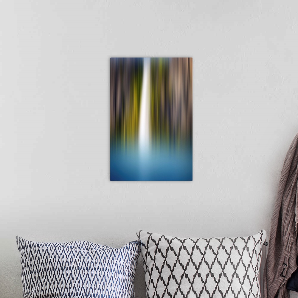 A bohemian room featuring Abstract photograph of a blurred waterfall with brown, green, blue, and white hues.