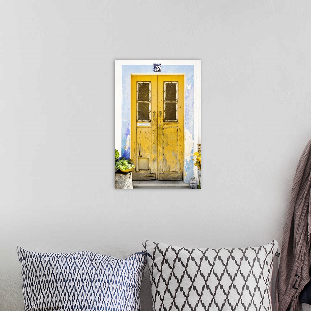 A bohemian room featuring It's an old yellow door entrance to a traditional house in Portugal.
