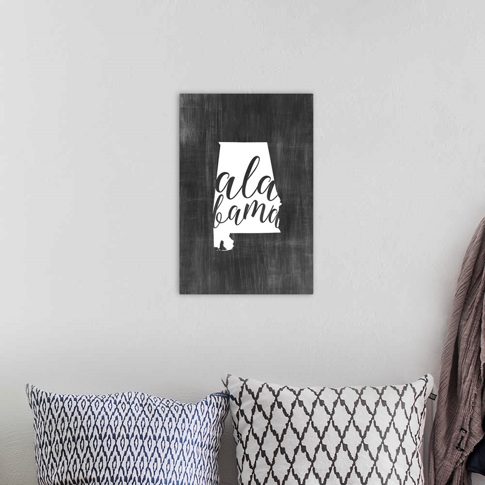 A bohemian room featuring Alabama state outline typography artwork.
