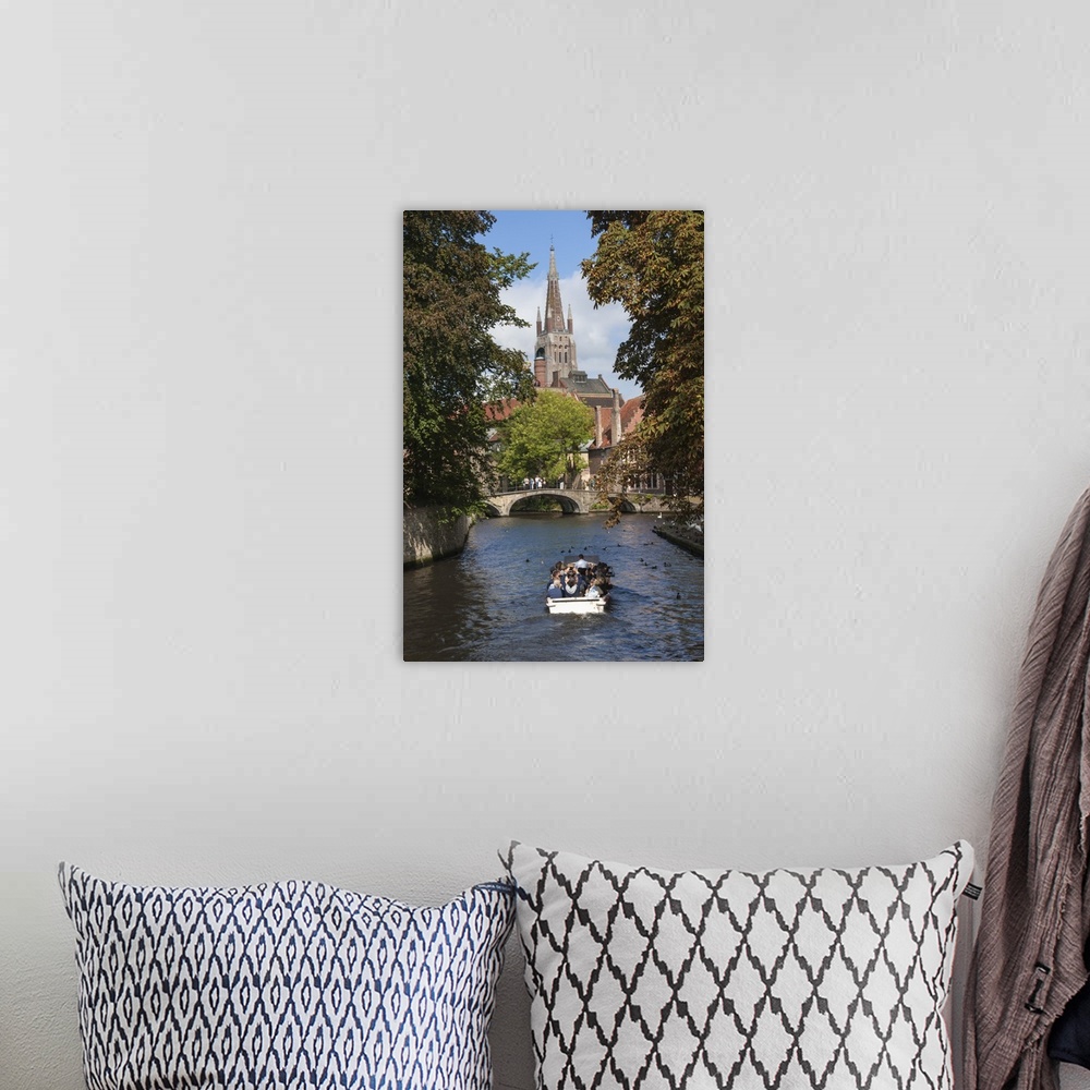 A bohemian room featuring Bridge to Begijnhof, and spire of Church of Our Lady, tourist launch, Bruges, UNESCO World Herita...