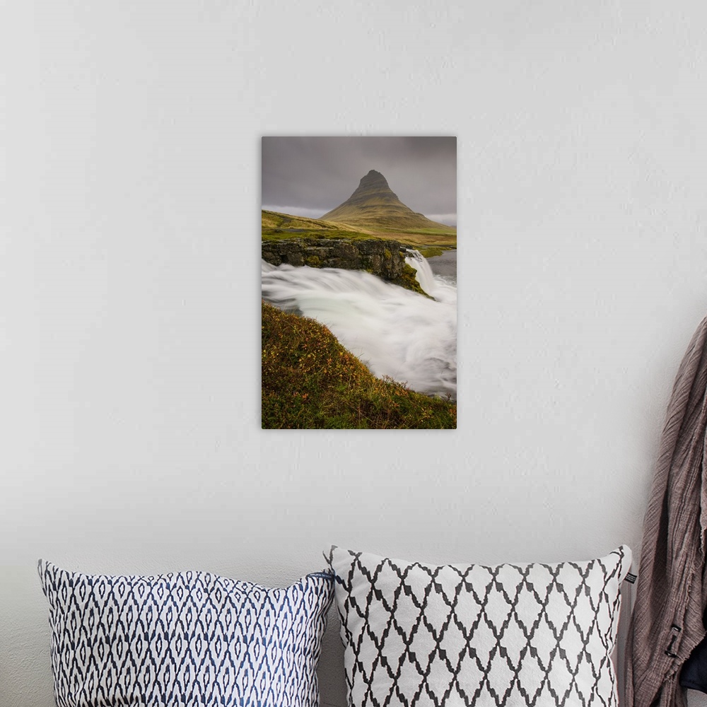 A bohemian room featuring Kirkjufellsfoss in autumn with hiker to show scale, Iceland, Polar Regions
