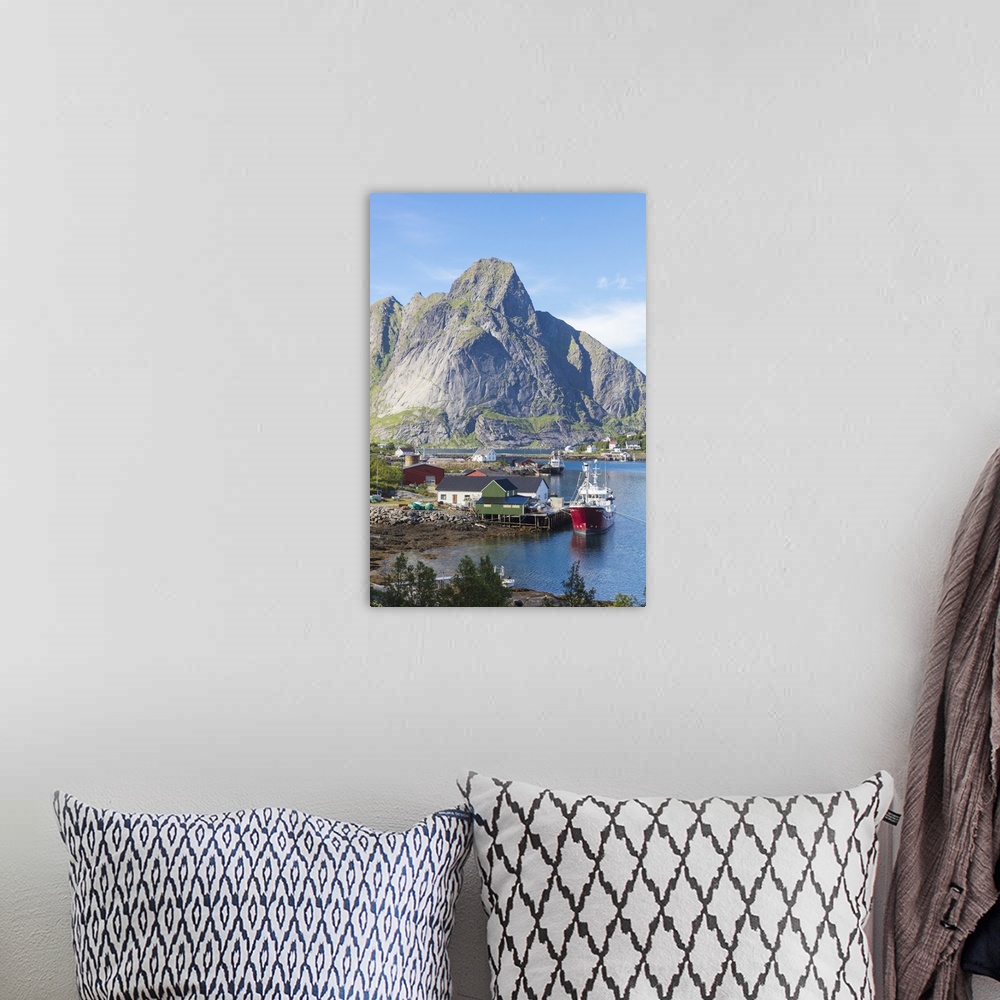 A bohemian room featuring Ship in the blue sea frames the fishing village and the rocky peaks, Reine, Moskenesoya, Lofoten ...