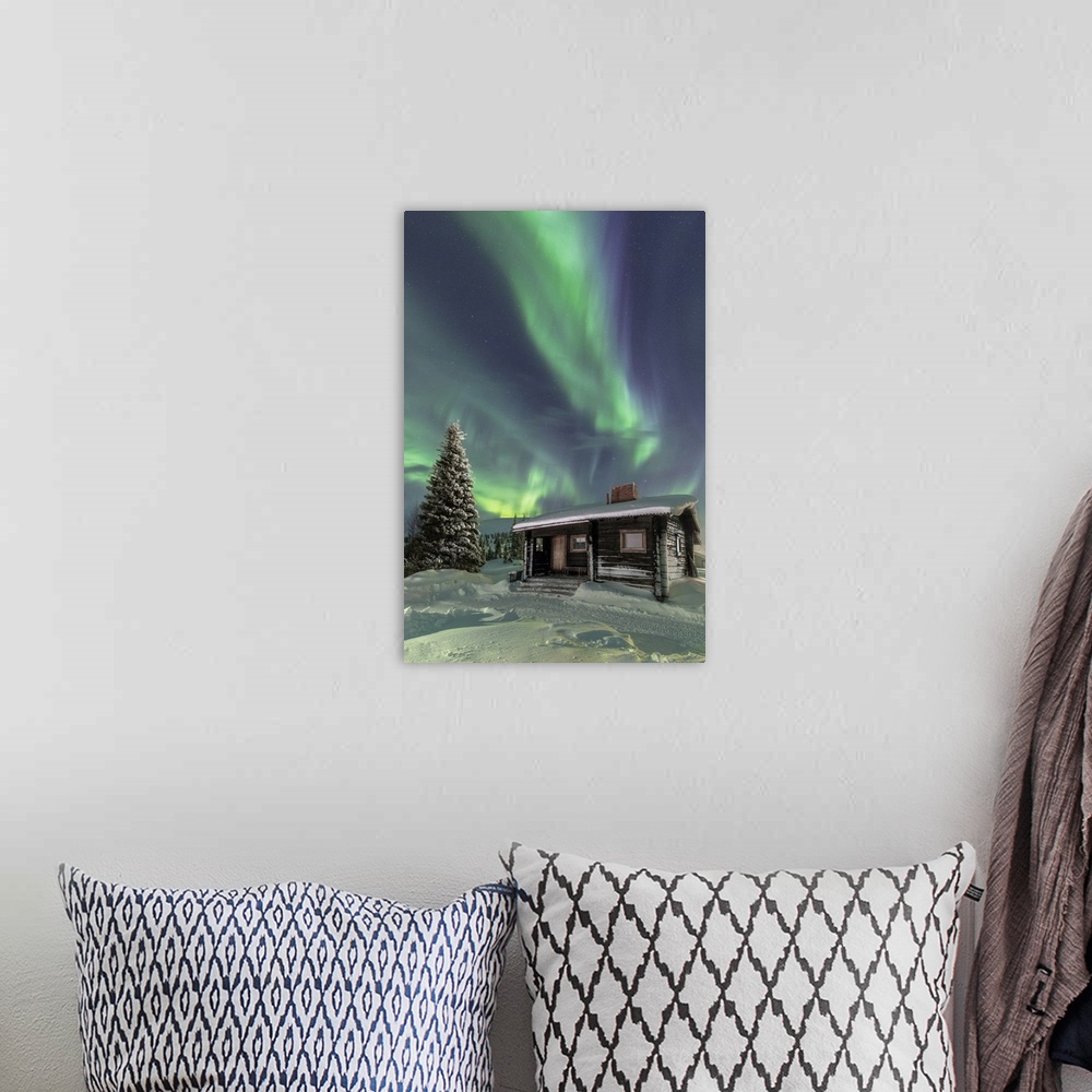 A bohemian room featuring The Northern Lights frame the wooden hut in the snowy woods, Pallas, Yllastunturi National Park, ...