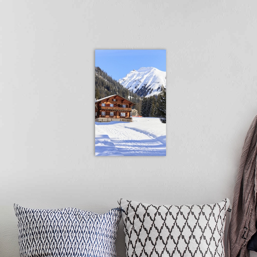 A bohemian room featuring Typical wooden hut framed by woods and snowy peaks, Langwies, district of Plessur, Canton of Grau...