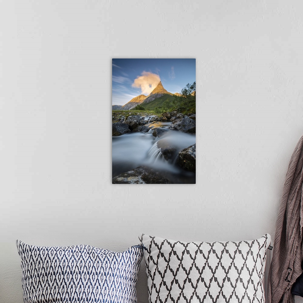 A bohemian room featuring Waterfall frames the Stetinden mountain peak illuminated by midnight sun, Tysfjord, Nordland, Nor...