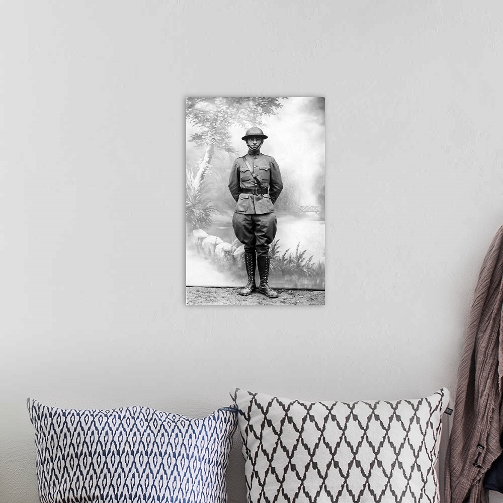 A bohemian room featuring Harry S. Truman standing in front of a standard postcard backdrop during the first World War.