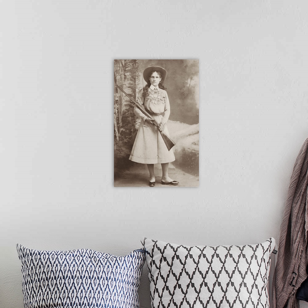 A bohemian room featuring Portrait of sharpshooter Annie Oakley holding a rifle.