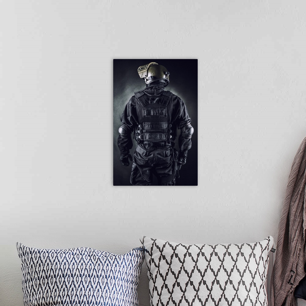 A bohemian room featuring Spec ops soldier on black background shot from behind.