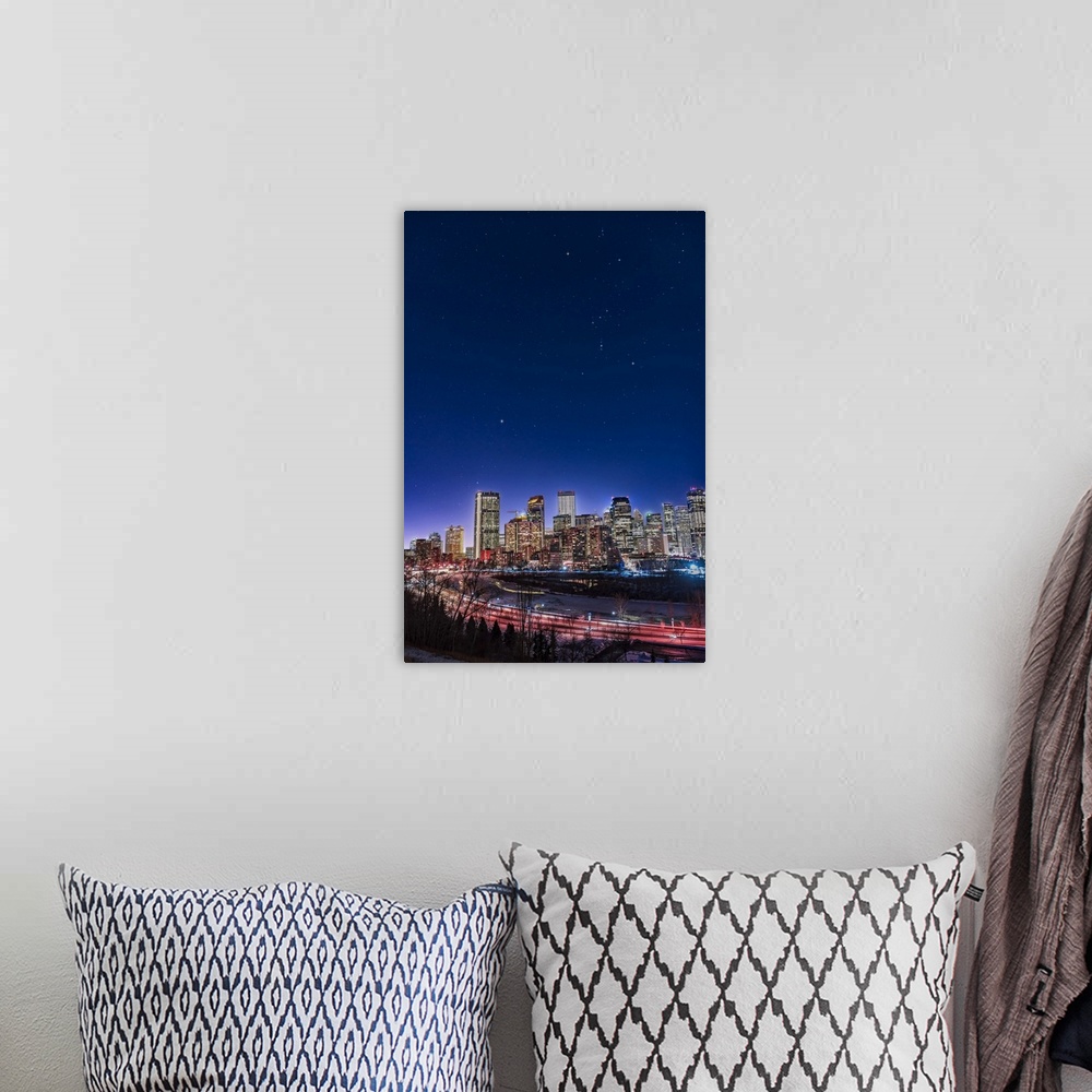 A bohemian room featuring An urban nightscape with the constellations of Orion and Canis Major over the skyline of Calgary,...