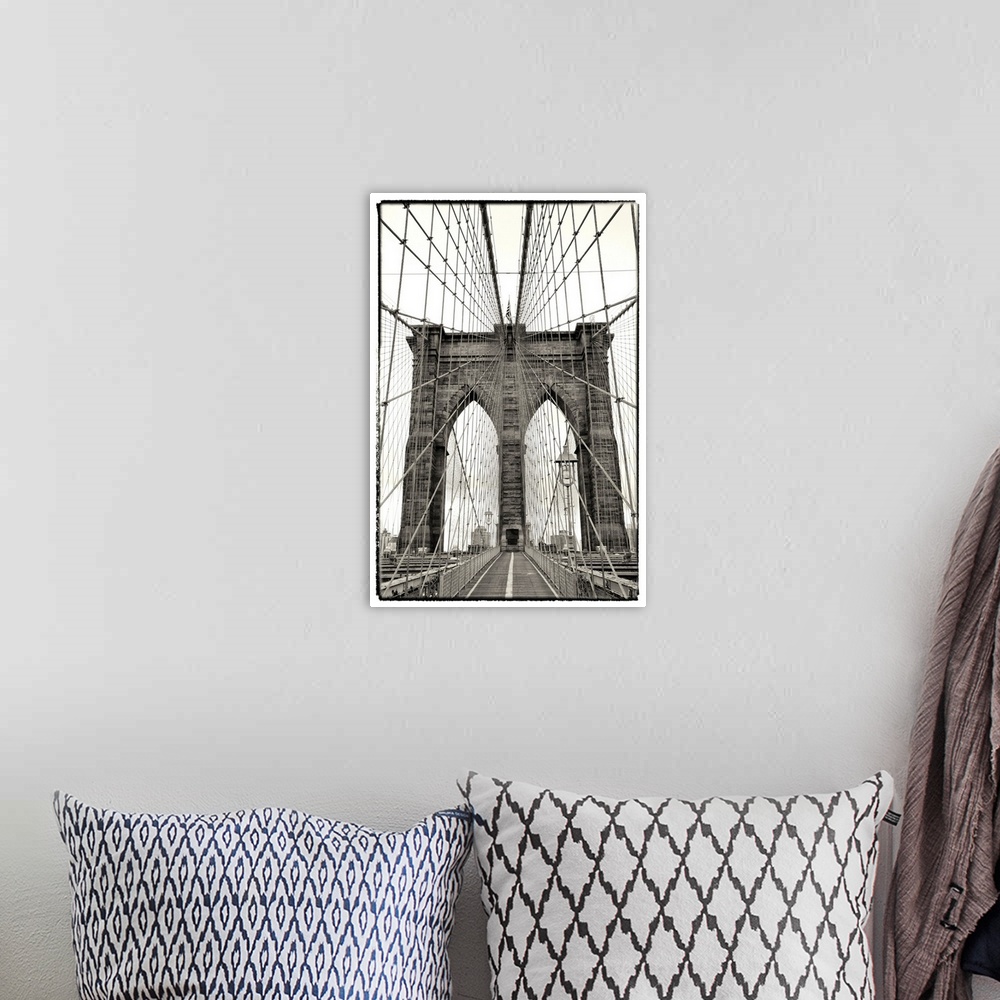 A bohemian room featuring Black and white photograph of a dramatic view of the Brooklyn Bridge.