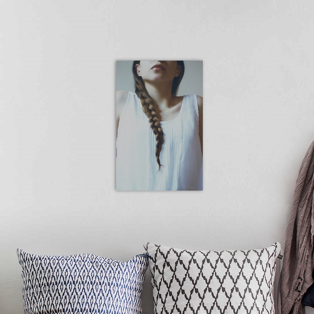 A bohemian room featuring faceless portrait of a girl with pale light and braided hair