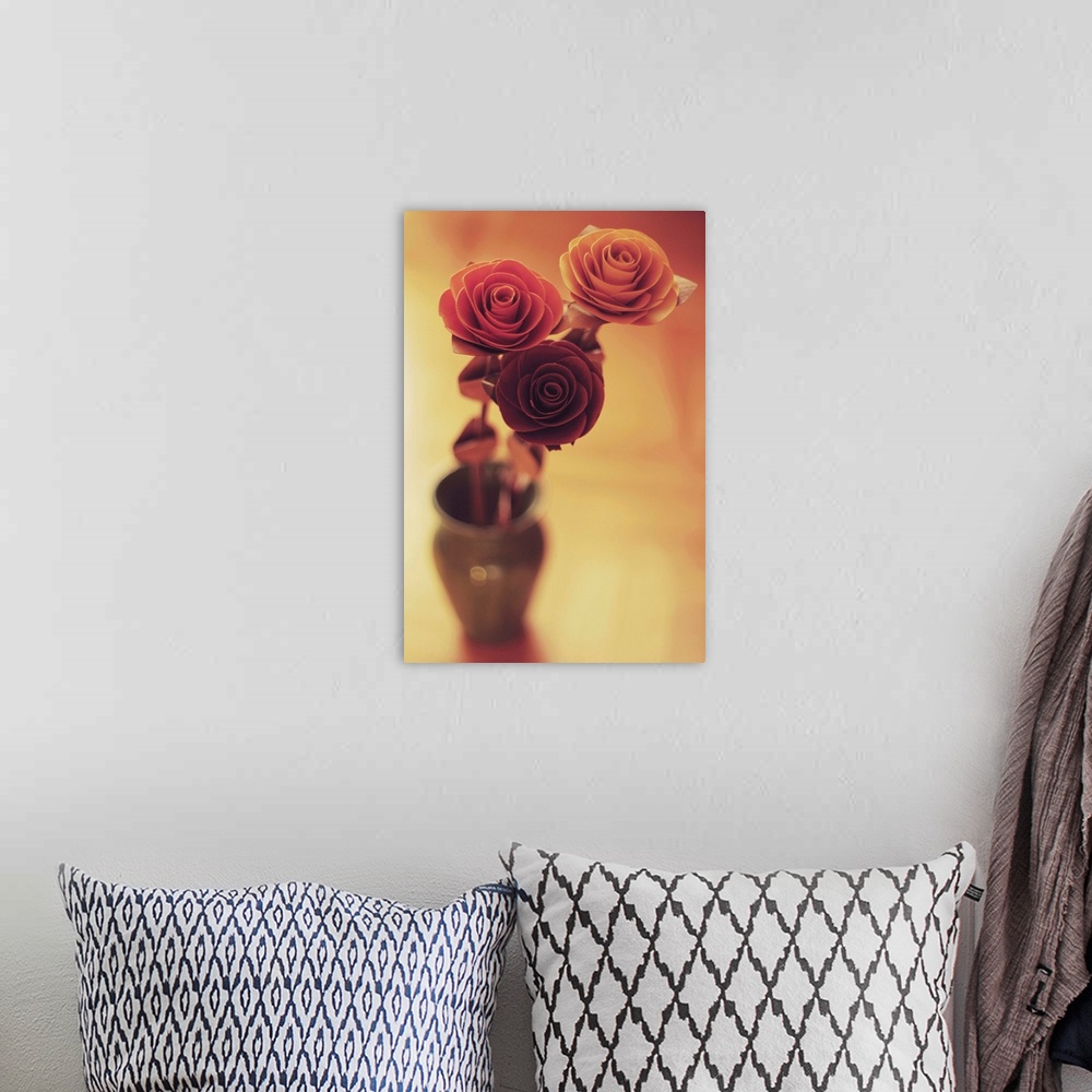 A bohemian room featuring Three colourful roses in a small vase