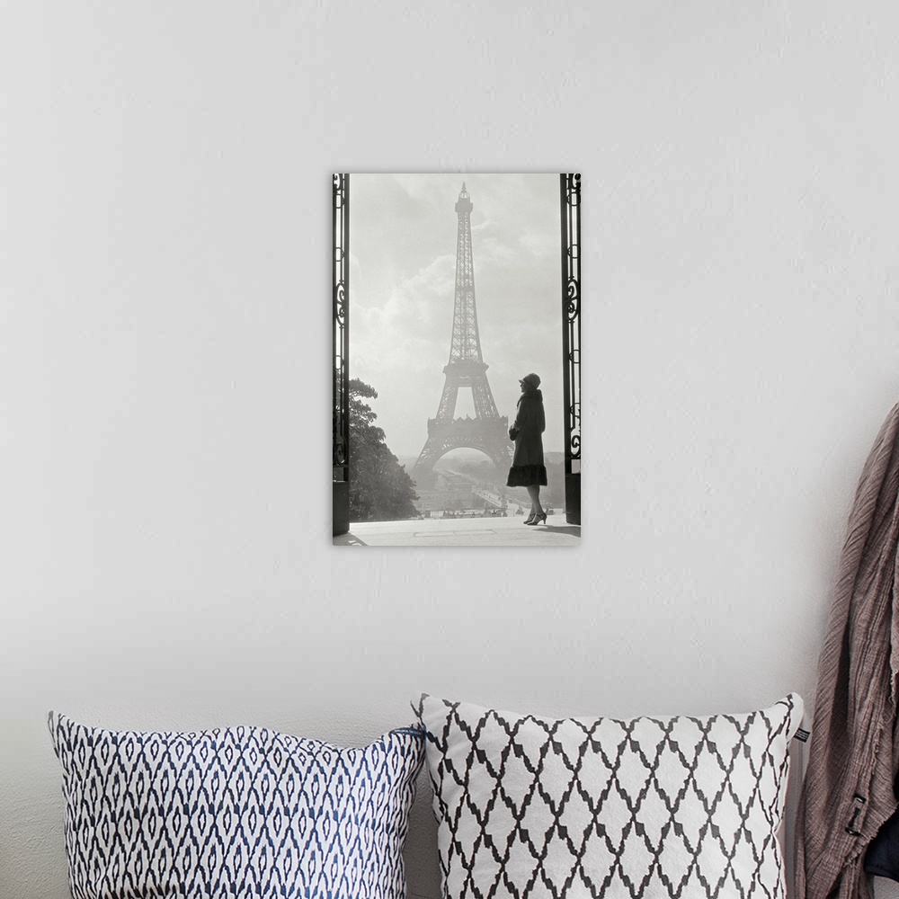 A bohemian room featuring Vintage photograph of a stylish woman standing in an art deco gateway with the Eiffel Tower in th...
