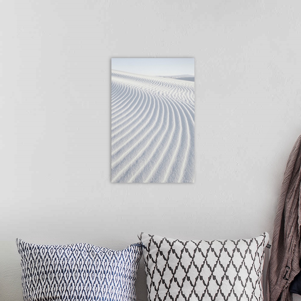 A bohemian room featuring A vertical photograph of ripples in the sand dunes created by the wind.