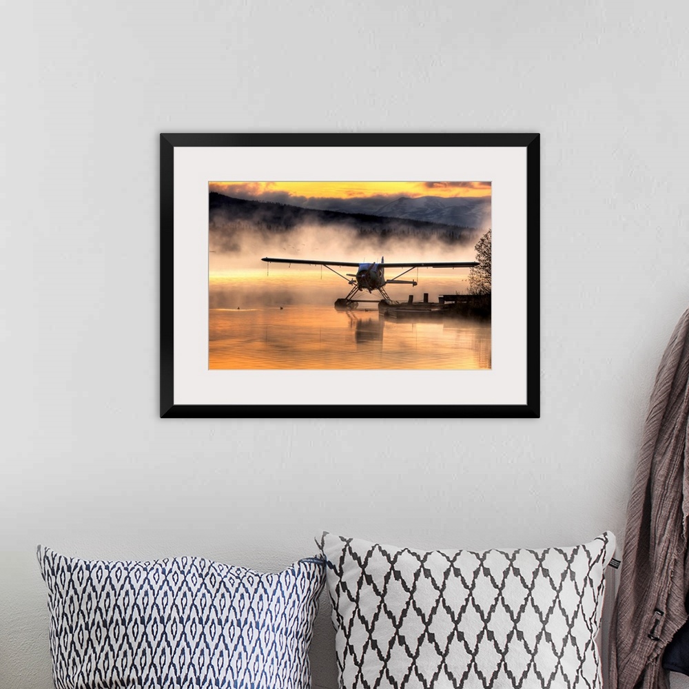 A bohemian room featuring Giant photograph displays a seaplane sitting next to a dock as a soft fog rolls over the water.  ...