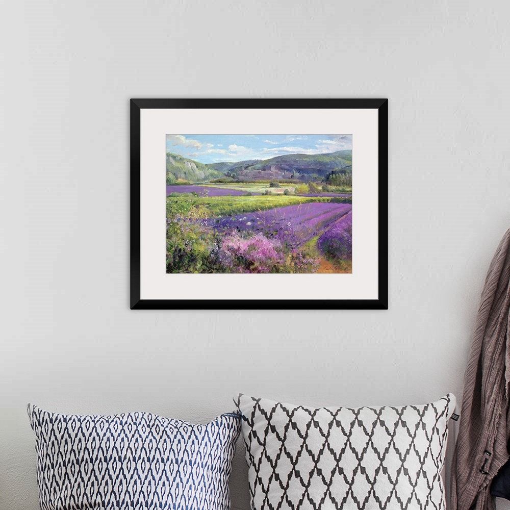 A bohemian room featuring Big painting of fields of lavender with rolling hills in the background. Cooling tones are featur...