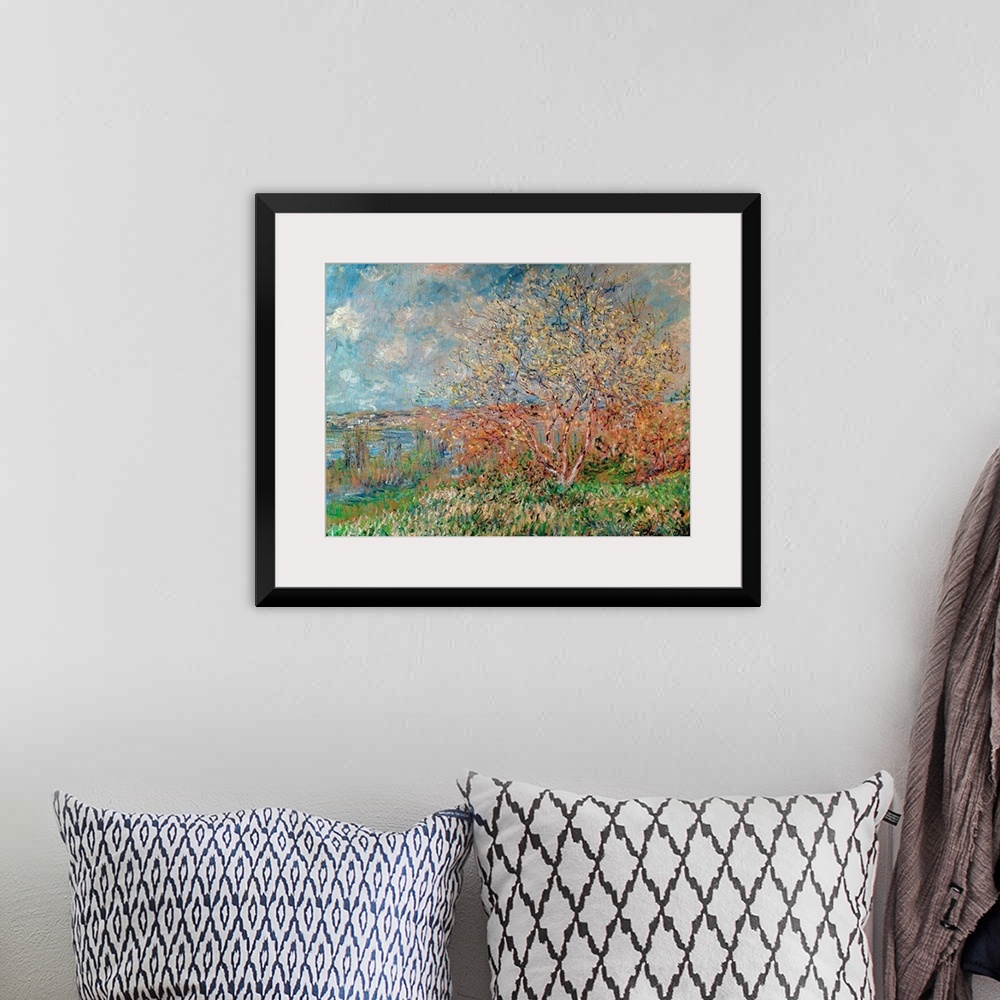 A bohemian room featuring An Impressionist landscape painting of a small tree growing on a hill overlooking a valley.