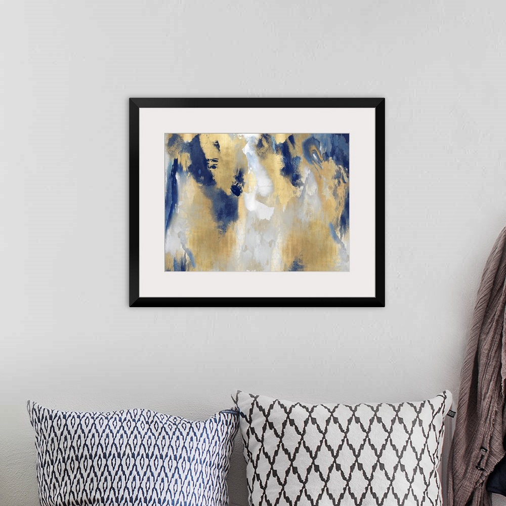 A bohemian room featuring A large, horizontal abstract painting in shades of indigo and gold. This statement piece of art w...