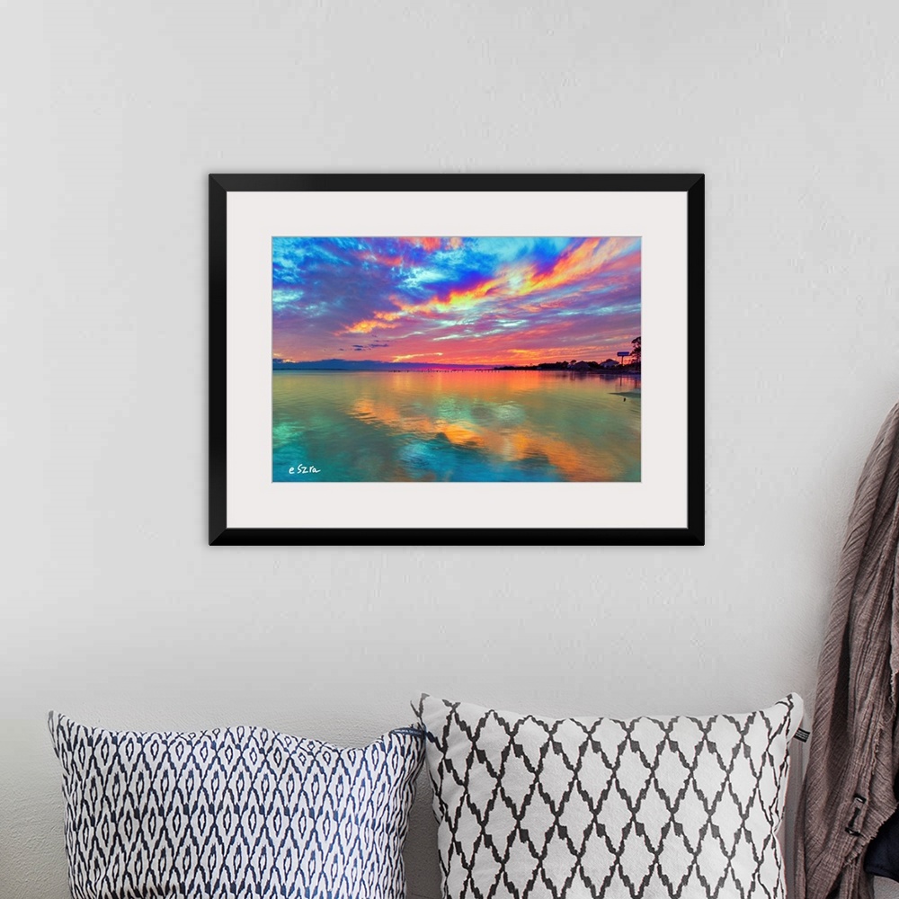 A bohemian room featuring Cloud streaks reflected in this pink sunset over the sea.