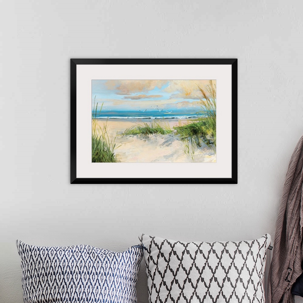 A bohemian room featuring Contemporary painting of a sandy beach with birds flying towards the ocean.