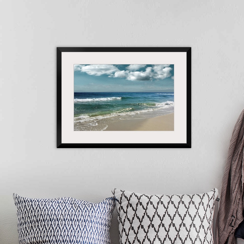 A bohemian room featuring This serene photo shows rippling waves as they approach the beach with puffy white clouds in the ...