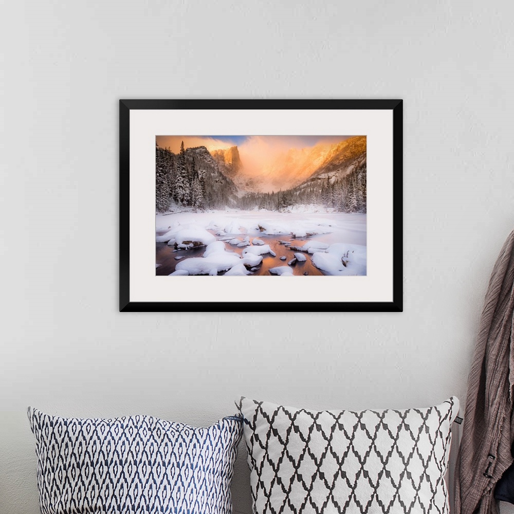 A bohemian room featuring Giant photograph of a snow covered landscape filled with trees surrounding and a frozen river run...
